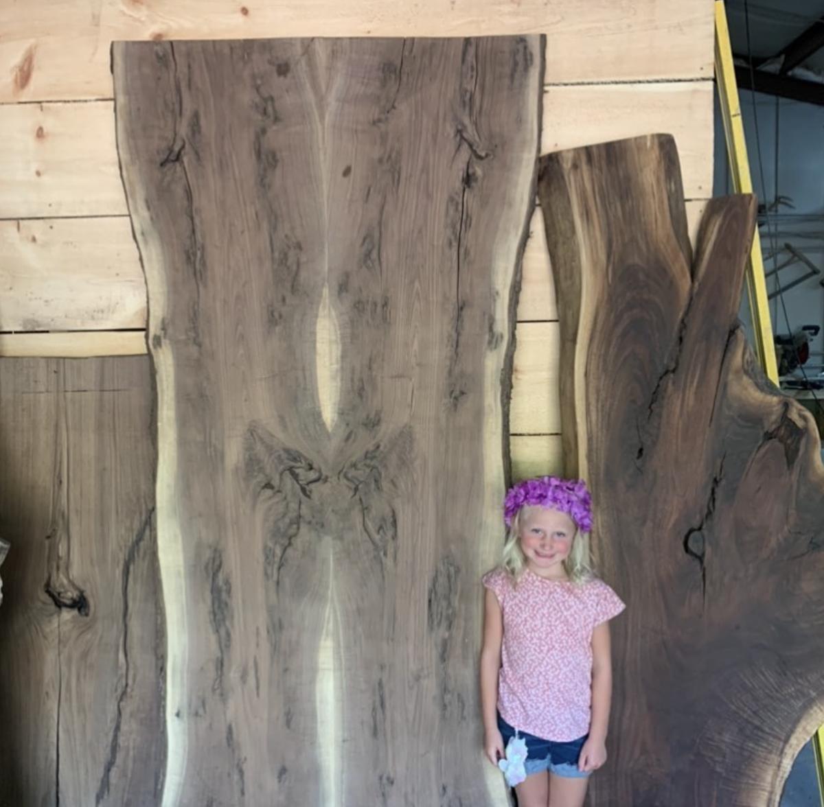 Tall live edge slabs standing upright in a shop