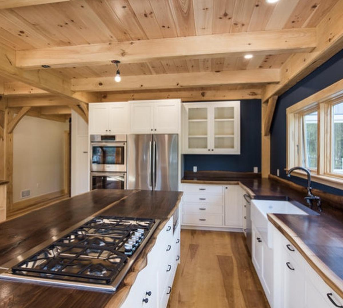 Kitchen with wood countertops and timber ceiling